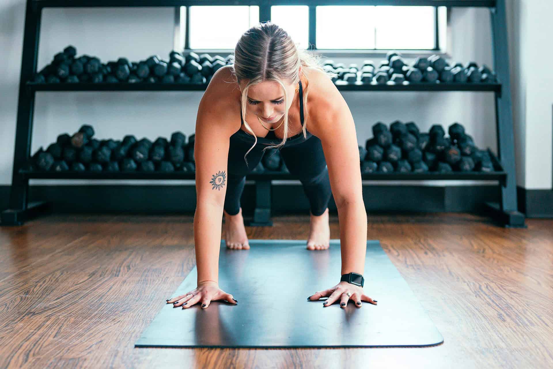 Woman doing a plank on yoga mat.