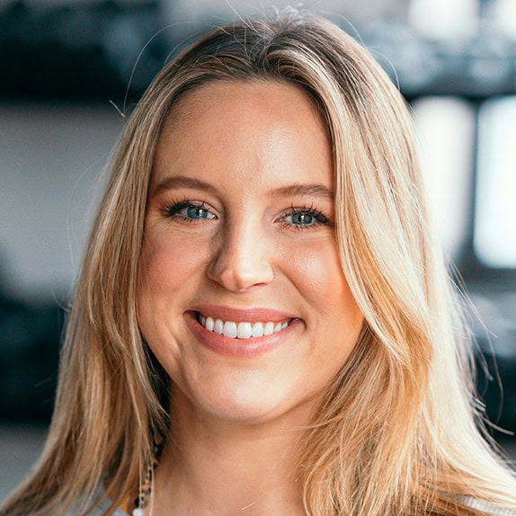 Smiling woman with long blonde hair.