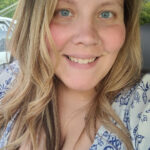Woman sitting in car with blue pattern shirt