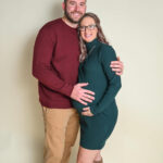 Husband and pregnant wife standing for photo