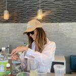 Woman standing at counter with drinks