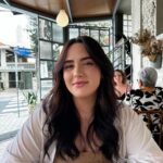 woman sitting outside at restaurant.